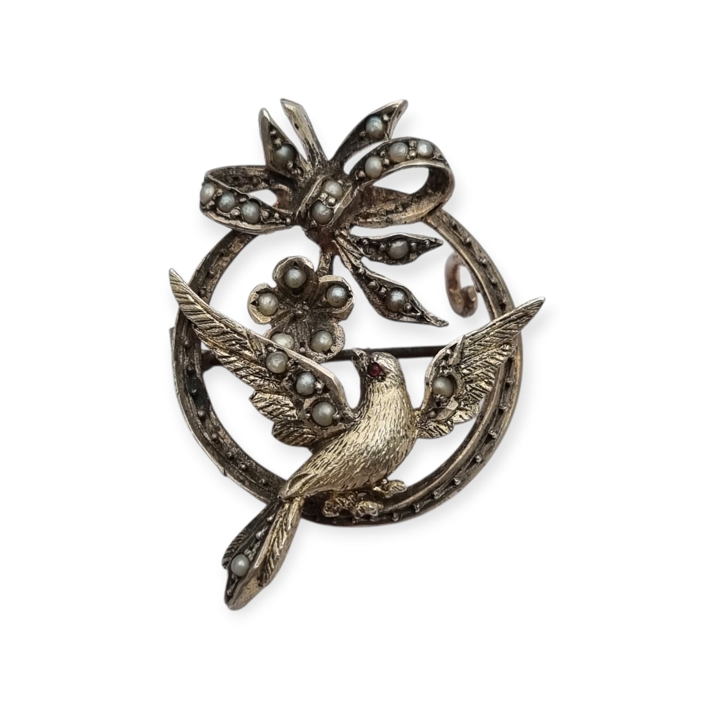 Broche eduardiano en plata con pájaro lazo perlas y rubí circa 1910