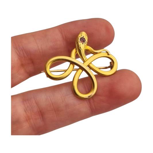 Broche francés FIX con serpiente entrelazada., oro laminado y piedra roja circa 1910