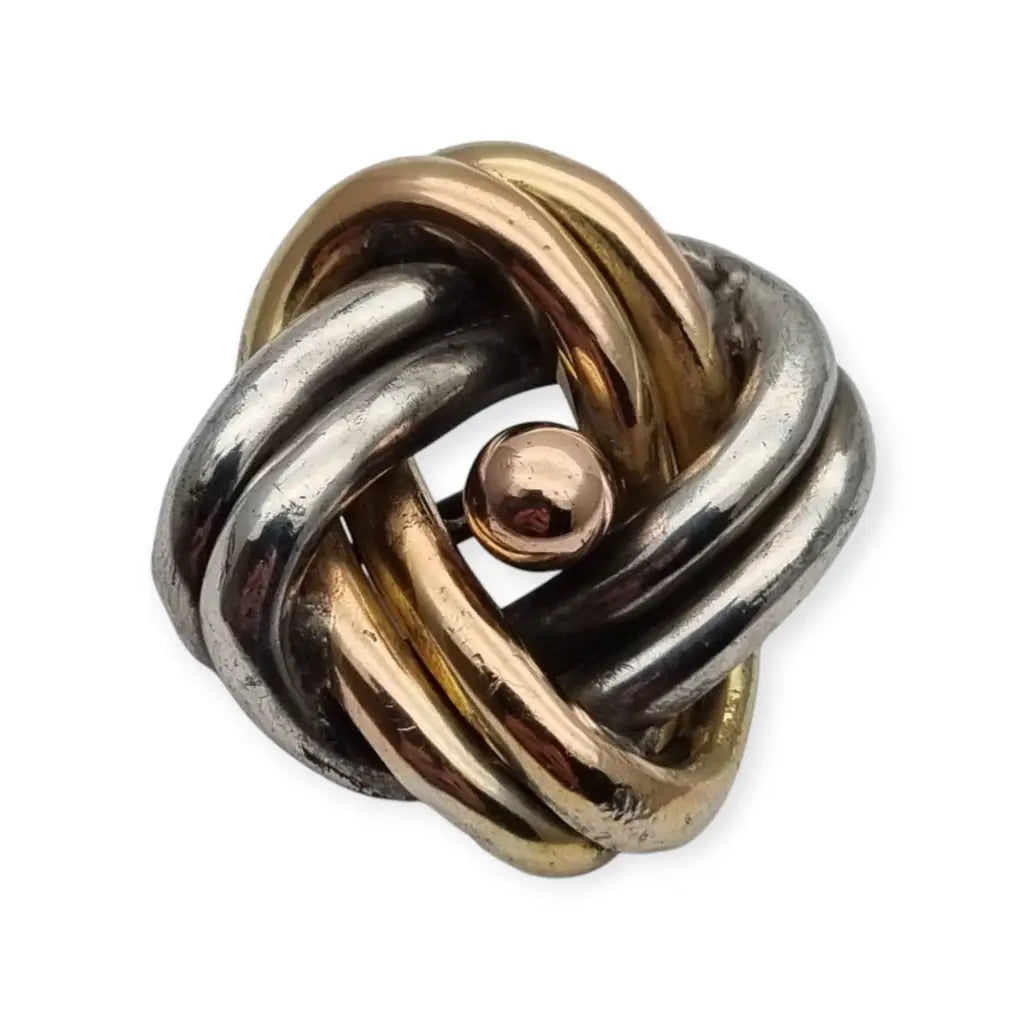 Broche antigua de nudo amor en plata años 40 con diseño simbólico