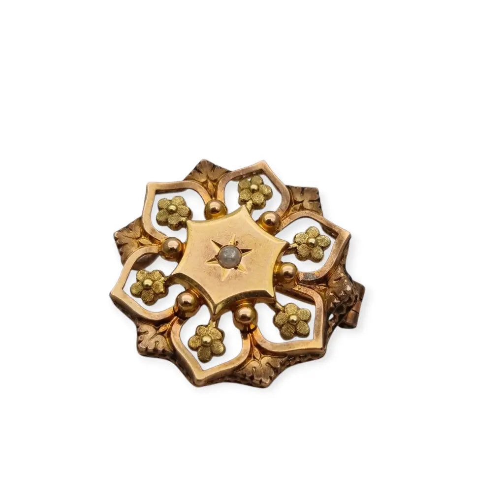 Broche francés vintage de oro FIX con diseño floral calado y una perla central