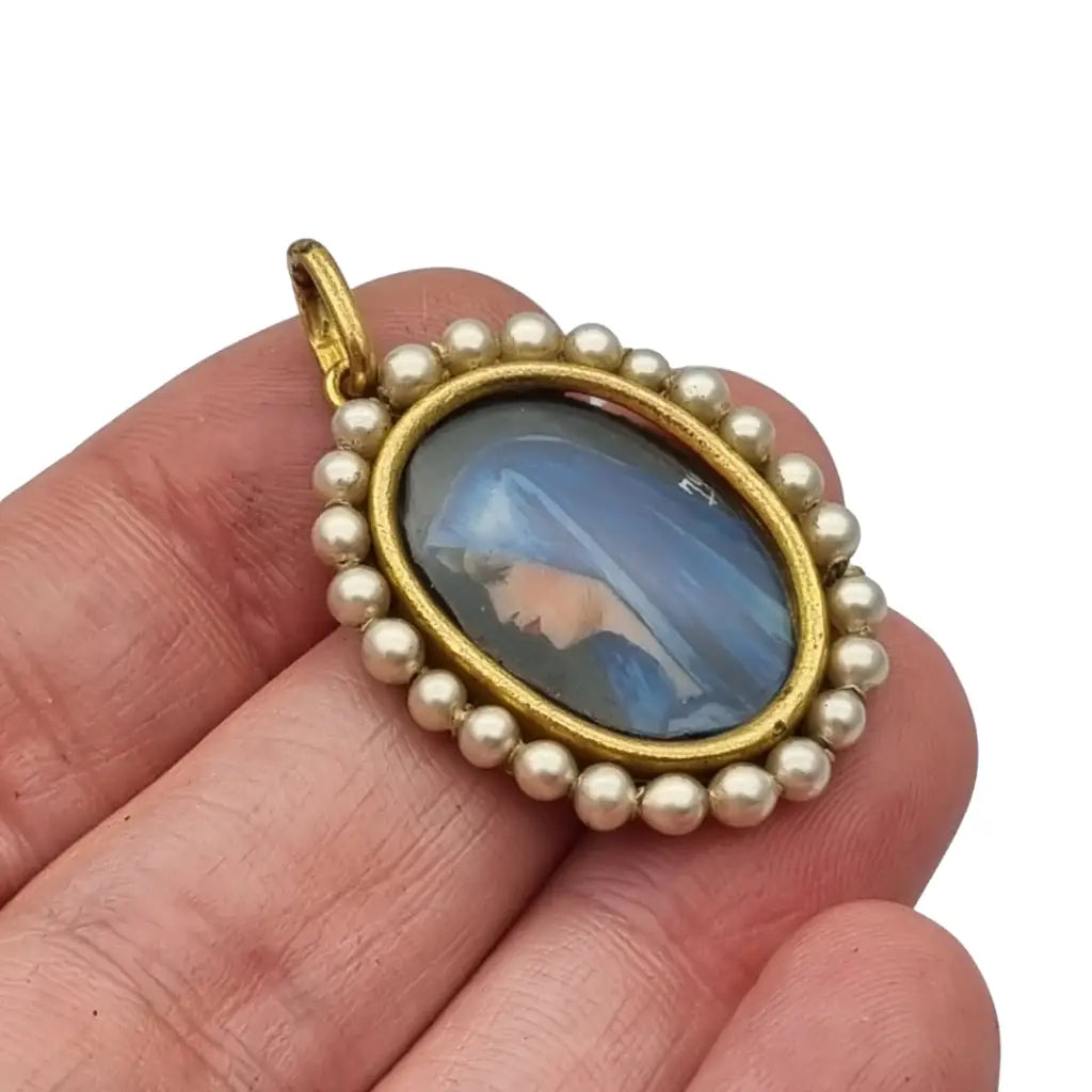 Colgante religioso con una Virgen azul pintada y firmada marco dorado