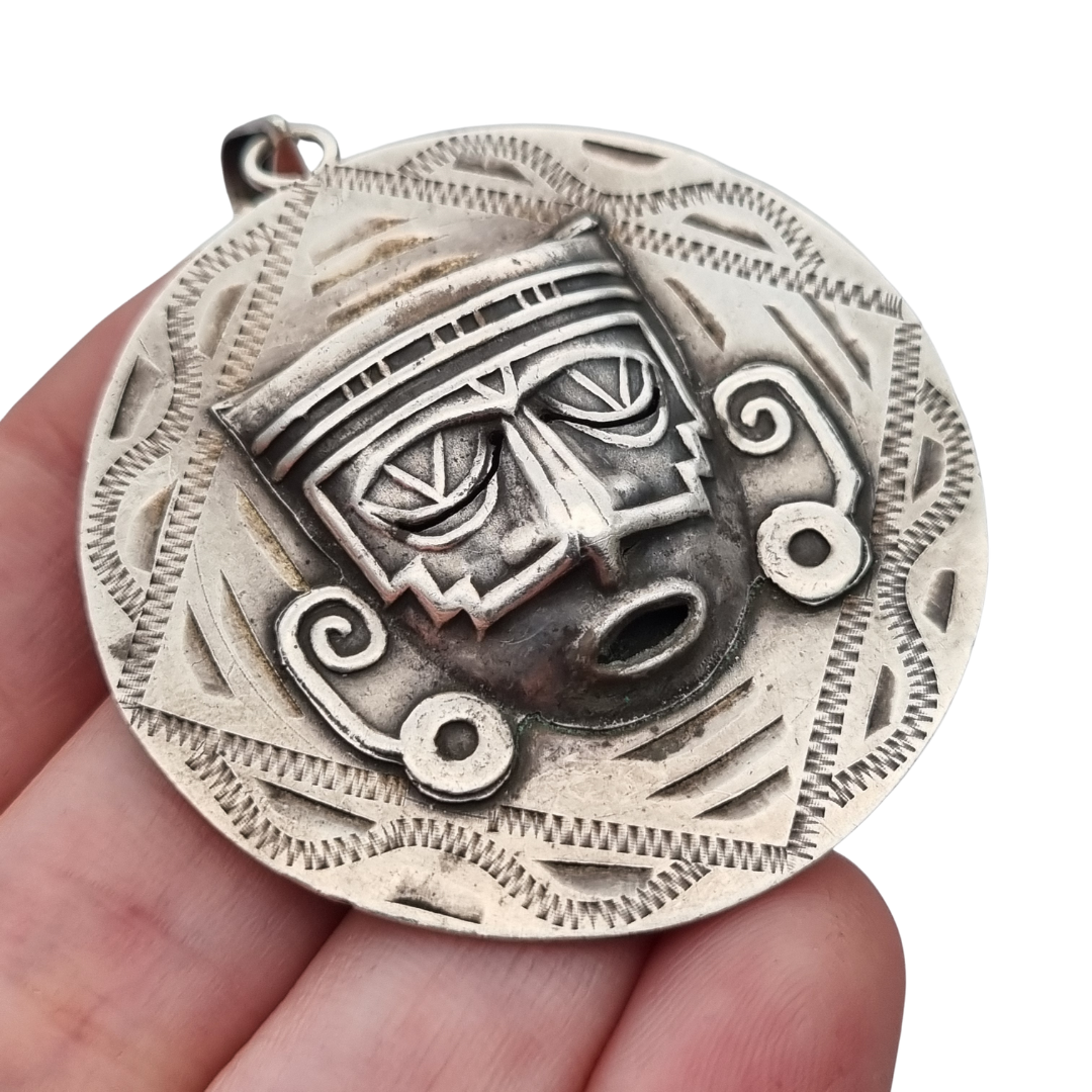 Reversible .925 sterling silver Aztec calendar and mask pendant, Mexico, 1960s-70s