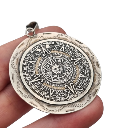 Reversible .925 sterling silver Aztec calendar and mask pendant, Mexico, 1960s-70s