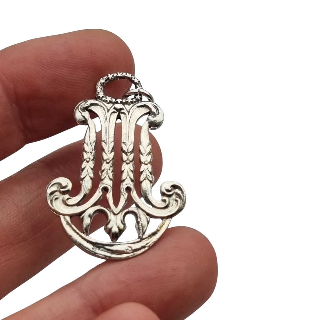 Colgante mariano monograma M en plata calada Art Nouveau, joya religiosa, circa 1900–1925