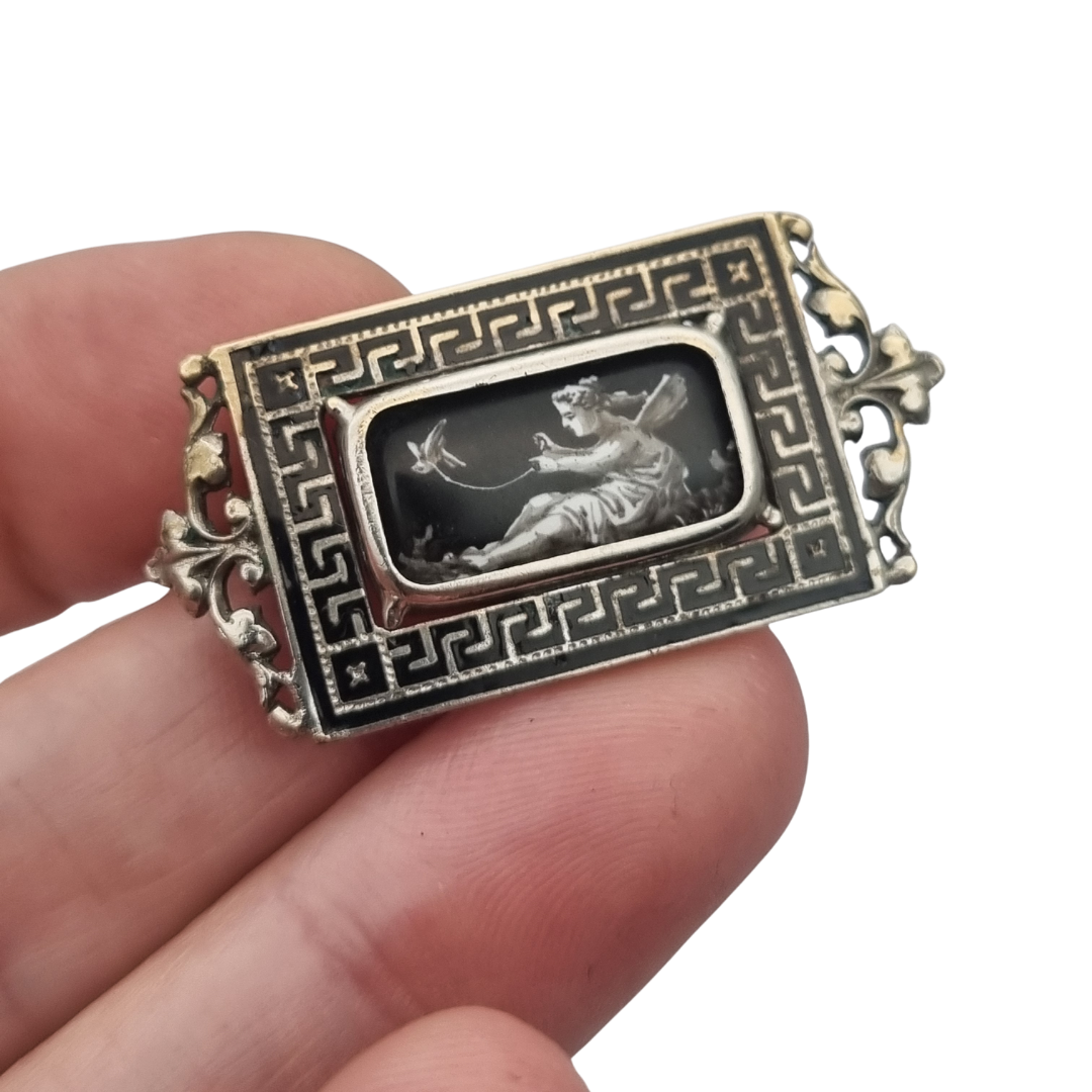 Antique rectangular metal and black enamel brooch with a classical scene, late 19th century