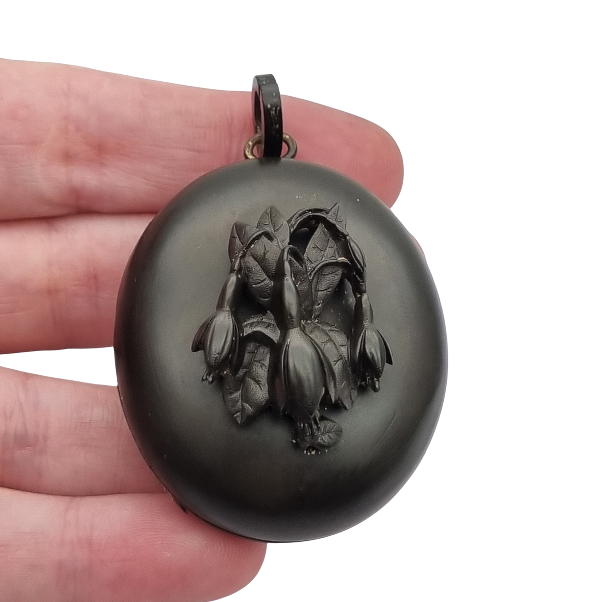 Victorian black vulcanite mourning locket with high-relief flowers, England, c. 1880–1900