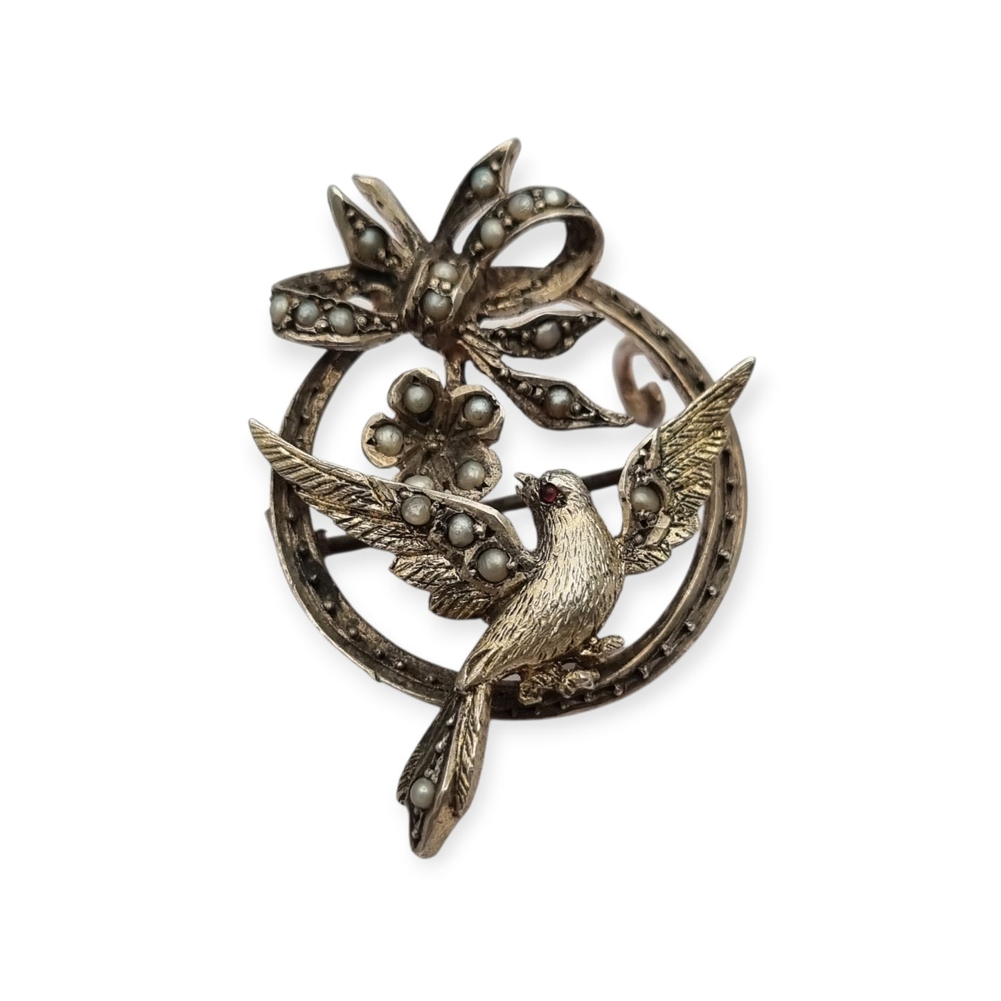 Broche eduardiano en plata con pájaro lazo perlas y rubí circa 1910