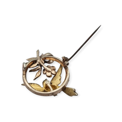 Broche eduardiano en plata con pájaro lazo perlas y rubí circa 1910