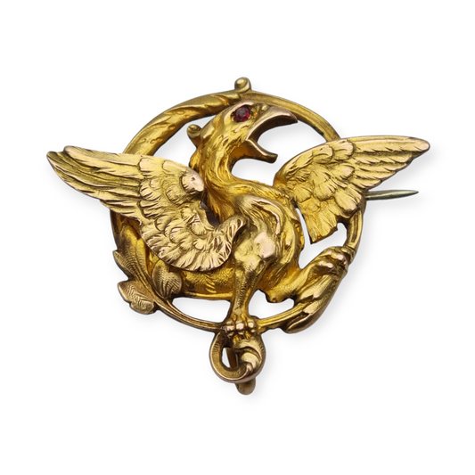 Broche Art Nouveau de grifo ORIA en oro laminado y ojo de rubí, circa 1910