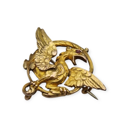 Broche Art Nouveau de grifo ORIA en oro laminado y ojo de rubí, circa 1910