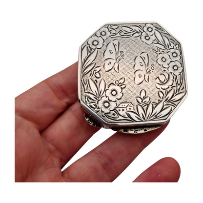 Antique octagonal powder compact in 800 silver engraved with butterflies and flowers, circa 1950