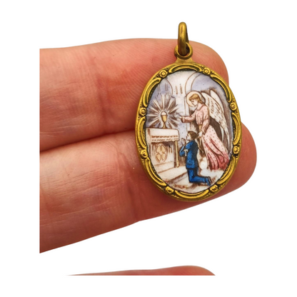 Art Nouveau religious medal in metal and enamel, circa 1910-20, angel and child in adoration