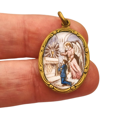 Art Nouveau religious medal in metal and enamel, circa 1910-20, angel and child in adoration