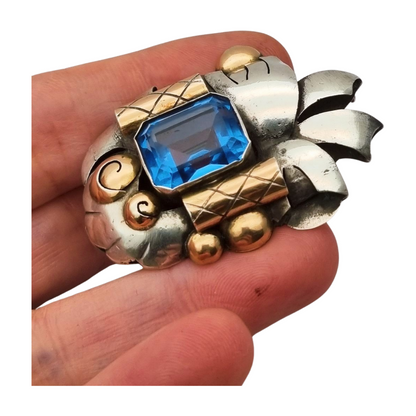 Art Deco Catalan brooch in silver with gold accents and simulated aquamarine, circa 1930-1940