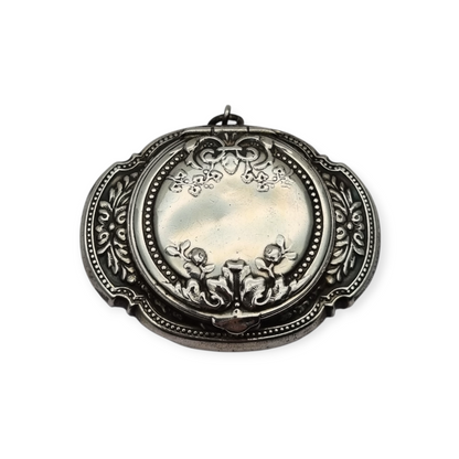 Antigua Polvera para chatelaine Modernista de plata con espejo interior, diseño floral, circa 1920.