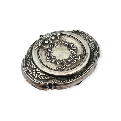 Antigua Polvera para chatelaine Modernista de plata con espejo interior, diseño floral, circa 1920.