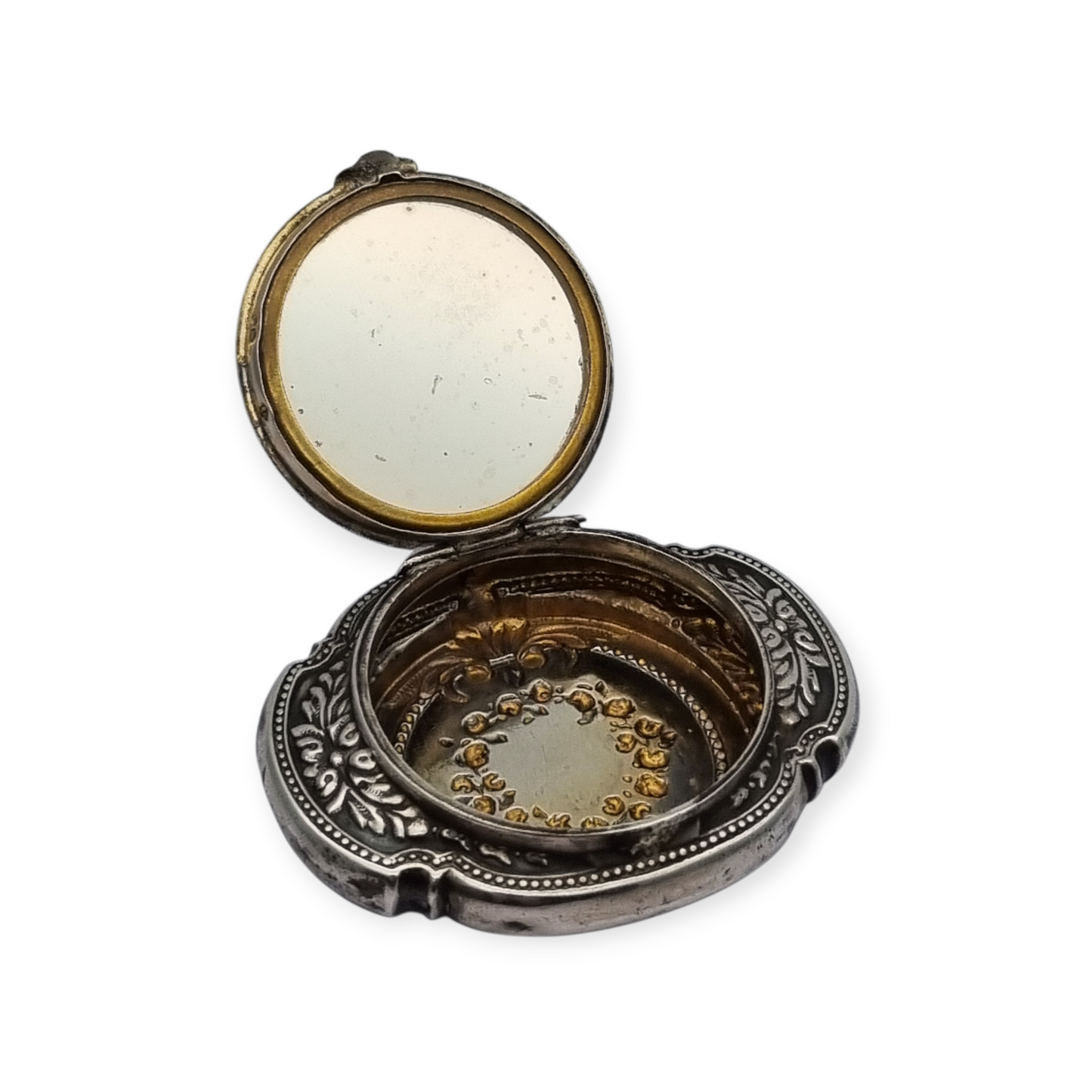 Antigua Polvera para chatelaine Modernista de plata con espejo interior, diseño floral, circa 1920.