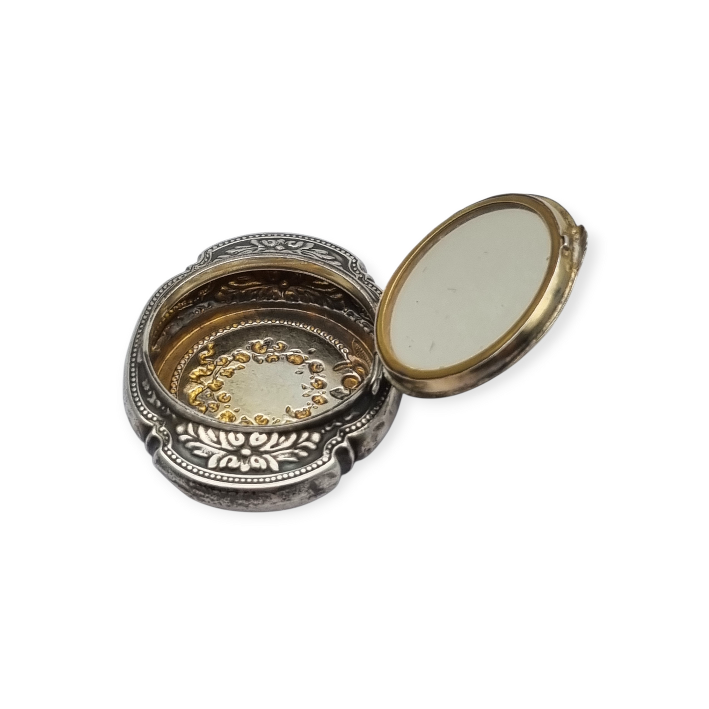 Antigua Polvera para chatelaine Modernista de plata con espejo interior, diseño floral, circa 1920.