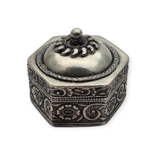 Hexagonal oriental ethnic silver box with floral relief and domed lid, circa 1970