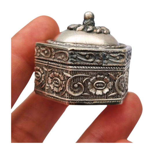 Hexagonal oriental ethnic silver box with floral relief and domed lid, circa 1970