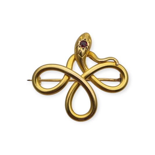 Broche francés FIX con serpiente entrelazada., oro laminado y piedra roja circa 1910
