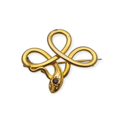 Broche francés FIX con serpiente entrelazada., oro laminado y piedra roja circa 1910