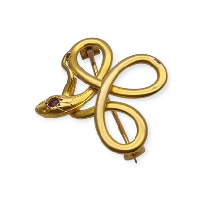 Broche francés FIX con serpiente entrelazada., oro laminado y piedra roja circa 1910