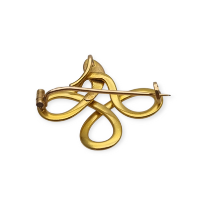 Broche francés FIX con serpiente entrelazada., oro laminado y piedra roja circa 1910