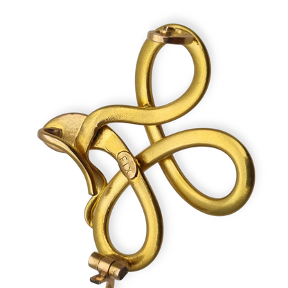 Broche francés FIX con serpiente entrelazada., oro laminado y piedra roja circa 1910