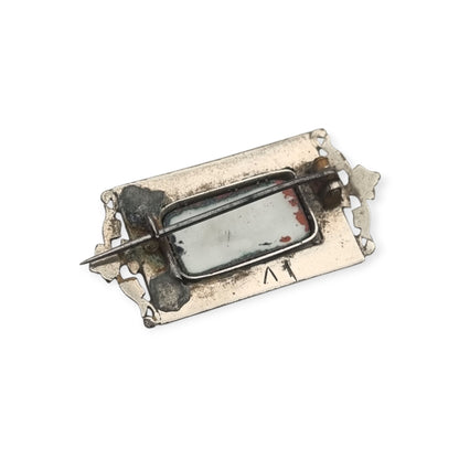 Antique rectangular metal and black enamel brooch with a classical scene, late 19th century