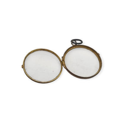 Antique round metal and beveled glass locket pendant, circa 1920