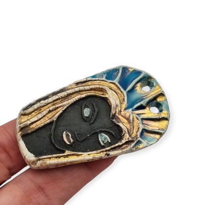 Handmade ceramic pendant with a Modernist Marian bust, enameled piece with golden highlights, European, 1960–1980s