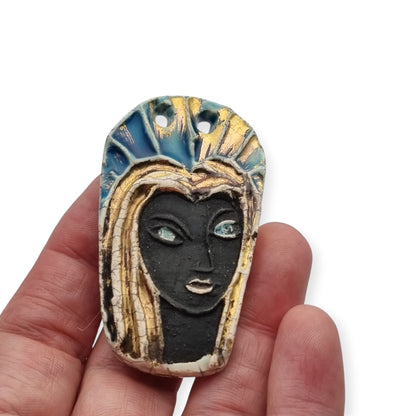 Handmade ceramic pendant with a Modernist Marian bust, enameled piece with golden highlights, European, 1960–1980s