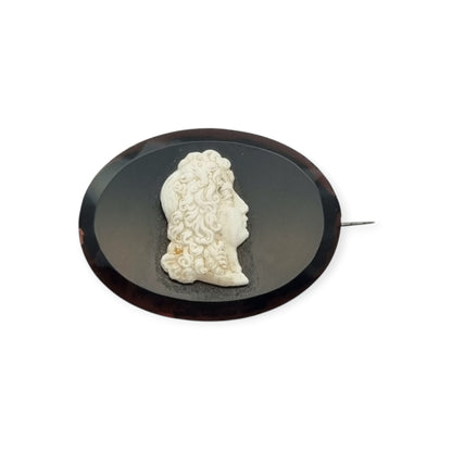 Vintage brooch with applied Neoclassical cameo, oval black plate and classic profile, circa 1930–1960