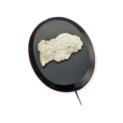 Vintage brooch with applied Neoclassical cameo, oval black plate and classic profile, circa 1930–1960