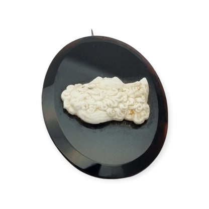 Vintage brooch with applied Neoclassical cameo, oval black plate and classic profile, circa 1930–1960