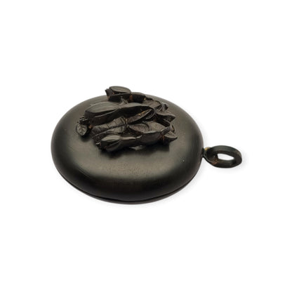 Victorian black vulcanite mourning locket with high-relief flowers, England, c. 1880–1900