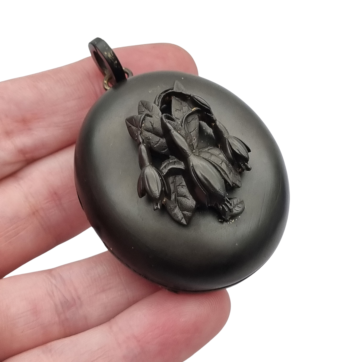 Victorian black vulcanite mourning locket with high-relief flowers, England, c. 1880–1900