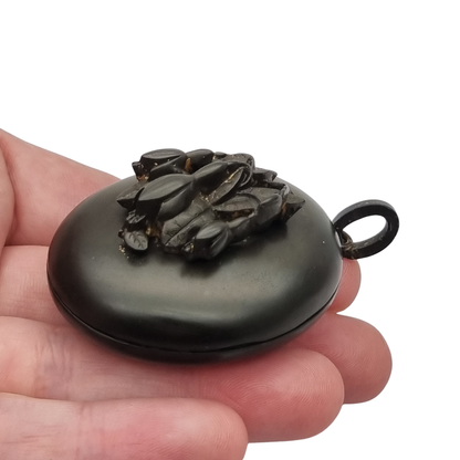 Victorian black vulcanite mourning locket with high-relief flowers, England, c. 1880–1900