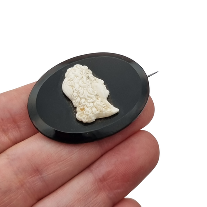Vintage brooch with applied Neoclassical cameo, oval black plate and classic profile, circa 1930–1960