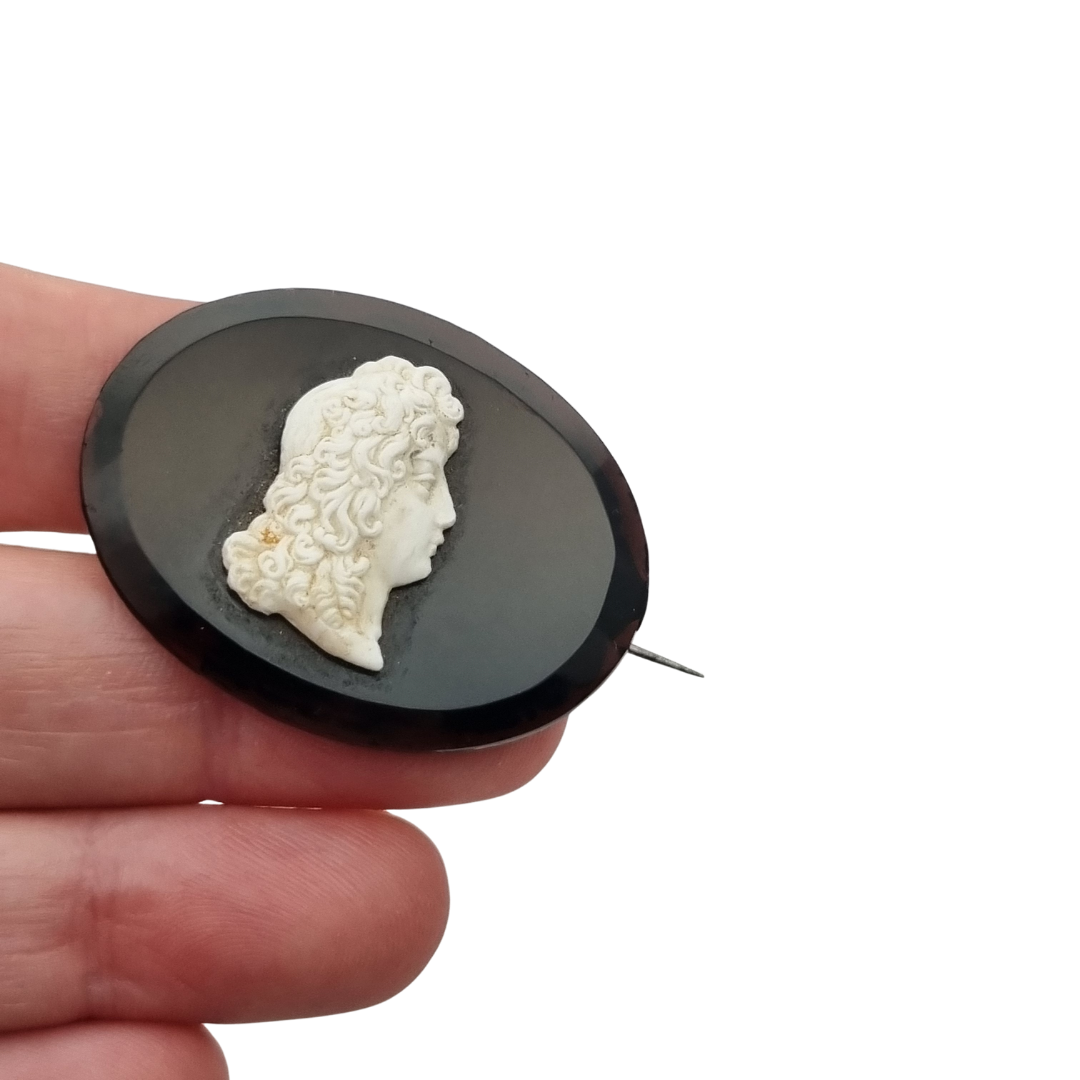 Vintage brooch with applied Neoclassical cameo, oval black plate and classic profile, circa 1930–1960