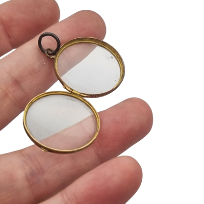 Antique round metal and beveled glass locket pendant, circa 1920