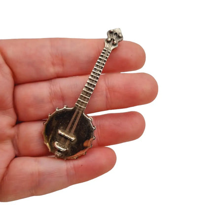 Figura banjo miniatura de plata ley instrumento musical para coleccionar.