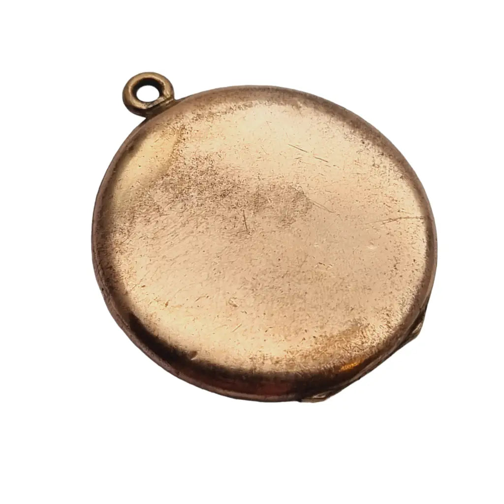 Medallón art deco de kollmar & jourdan dorado con esmalte y piedra rosa. 1930.