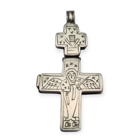 Antique Byzantine-style silver reliquary cross with engraved religious scenes.