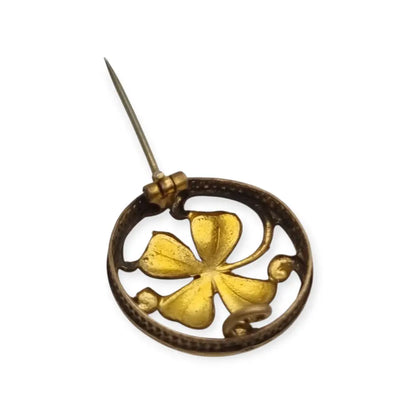 Broche antiguo Art Nouveau en metal dorado flor calada con cristal rojo central