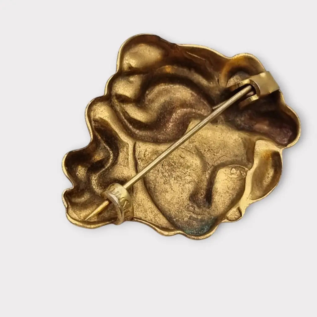 Broche de cabeza contemporáneo marca sunsilk en latón dorado. Bisutería
