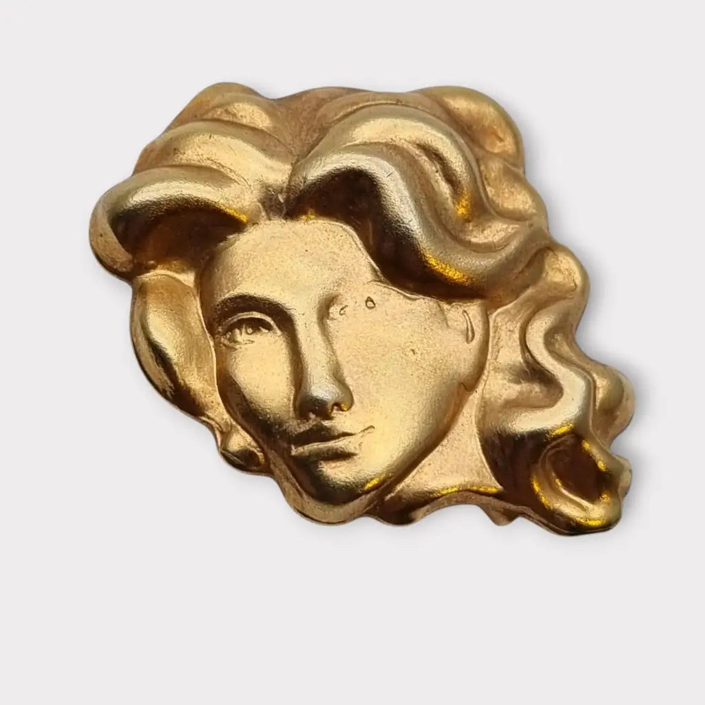 Broche de cabeza contemporáneo marca sunsilk en latón dorado. Bisutería