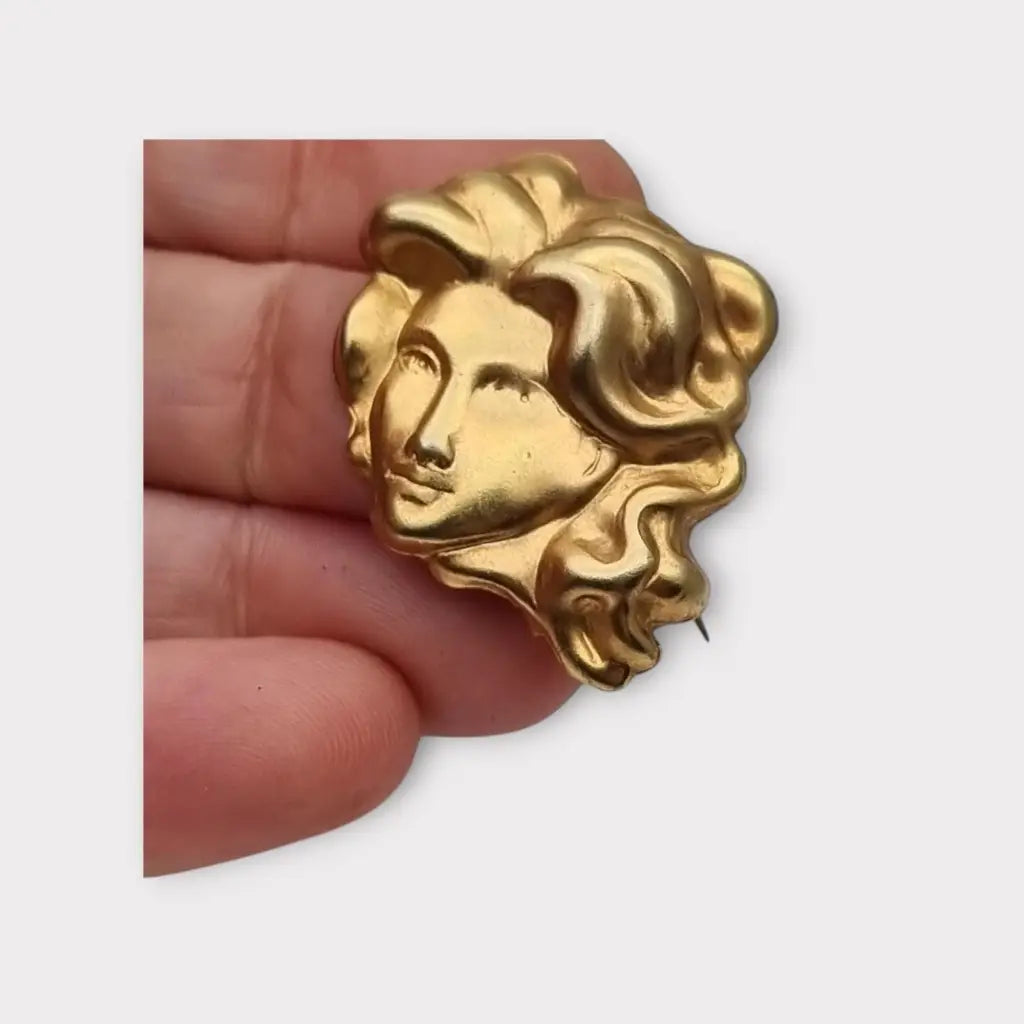 Broche de cabeza contemporáneo marca sunsilk en latón dorado. Bisutería
