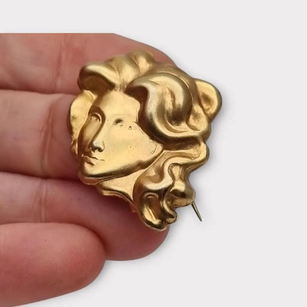 Broche de cabeza contemporáneo marca sunsilk en latón dorado. Bisutería